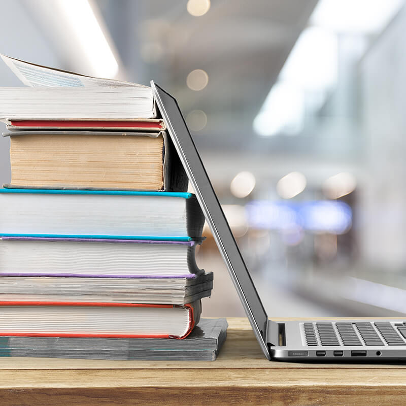 Books and a laptop on a desk